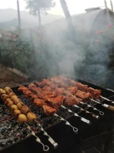 a bunch of food cooking on a grill at Anush`s B&B in Tatʼev