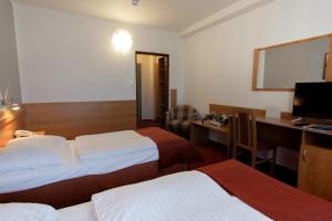 Postel nebo postele na pokoji v ubytování Hotel Globus