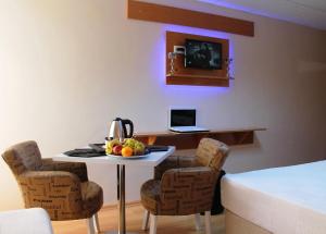 a kitchen with a table and chairs and a laptop at Avcılar İnci Hotel in Istanbul