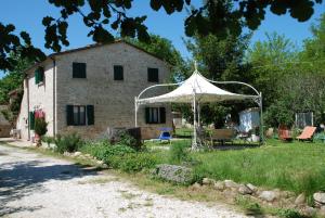 a white tent in front of a building at B&B Mulini Venturi in Saludecio