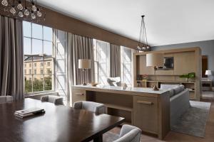 a kitchen and dining room with a table and chairs at Kimpton - Blythswood Square Hotel, an IHG Hotel in Glasgow