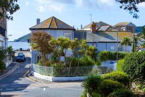 a house with palm trees on the side of a street at The Summer House in Penzance
