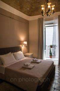 a bedroom with a bed with two towels on it at La Dimora del Falconiere - Luxury Suites in Sulmona