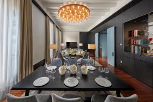 a dining room with a black table and chairs at Mandarin Oriental, Milan in Milan