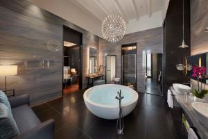 a large bathroom with a tub and two sinks at Mandarin Oriental, Milan in Milan