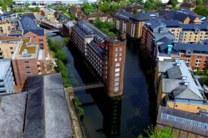 an overhead view of a city with a bridge over a river at I Should Cocoa (York) - Seebohm in York