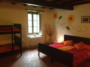 a bedroom with a bed with a flower mural on the wall at Agriturismo Le Dogane in Piteglio