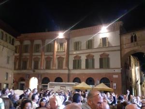 a crowd of people standing in front of a building at La Casa Di Miri in Foligno