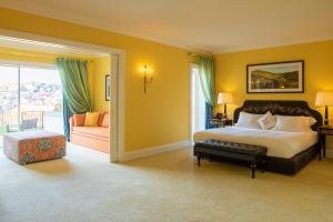 a bedroom with a king sized bed and a balcony at The Yeatman in Vila Nova de Gaia