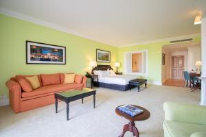 a hotel room with a bed and a couch at The Yeatman in Vila Nova de Gaia