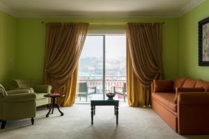 a living room with a couch and a large window at The Yeatman in Vila Nova de Gaia