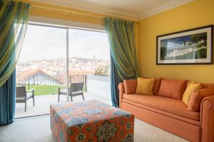 a living room with a couch and a large window at The Yeatman in Vila Nova de Gaia