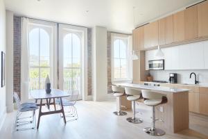 a kitchen with a table and chairs in a room at Sonder Gravier Place in New Orleans