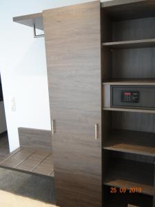 a kitchen with a cupboard with a microwave in it at Apartmenthaus Vogel in Neuhof