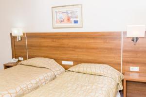 Postel nebo postele na pokoji v ubytování Hotel Burgas