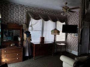 a living room with a dresser and a window at Topaz Motel - Flagler Beach in Flagler Beach