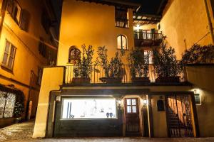a building with a garage with potted plants on top at Lake Charming Apartment in Cernobbio
