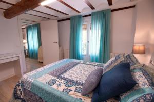a bedroom with a bed with a quilt on it at cuencaloft trinidad in Cuenca