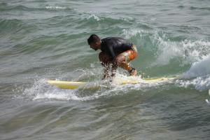 a man riding a wave on a surfboard in the ocean at Tayought Surf House in Taghazout