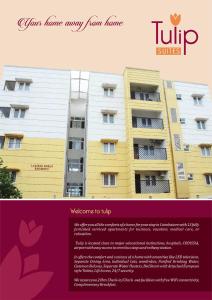 a website for a hotel with a yellow and white building at Tulip Suites in Coimbatore