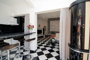 a kitchen with a black and white checkered floor at Apartments Kruna Jovanović in Sutomore