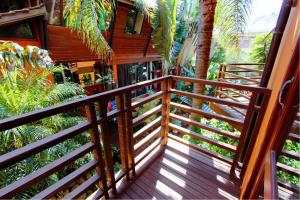 a balcony of a house with a wooden railing at Pousada Vila Boa Vida in Bombinhas