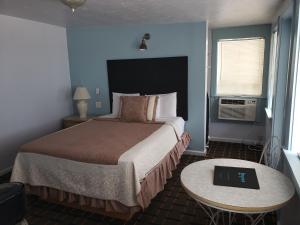 a hotel room with a bed and a table at Topaz Motel - Flagler Beach in Flagler Beach