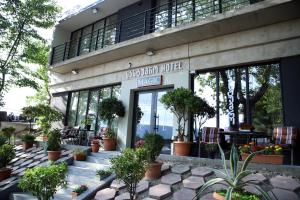 Magic Hotel في تبليسي: مبنى أمامه نباتات الفخار
