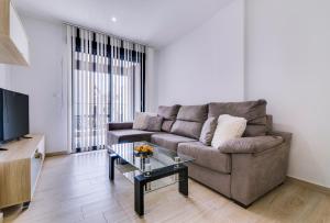 a living room with a couch and a coffee table at Apartamento Pinada Beach- La Mata in La Mata