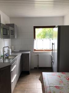 a small kitchen with a sink and a window at Pension ,,Vier Tore'' in Neubrandenburg