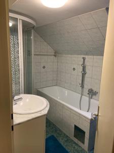 a bathroom with a bath tub and a sink at Serschenhof- Auszeit über dem Stall in Leutschach