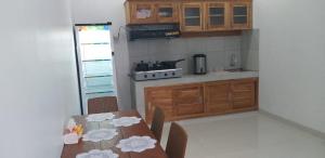 a kitchen with a table and chairs in a room at Queen Guest house tulamben in Tulamben