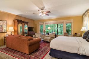 a bedroom with a bed and a living room at The Stockade Bed and Breakfast in Baton Rouge