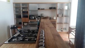a kitchen with a long counter with a stove at Spacious Dream Villa near Monaco in Roquebrune-Cap-Martin