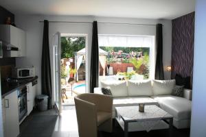 a living room with a white couch and a table at AdBurg-Hom in Homburg
