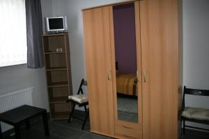 a wooden cabinet with a mirror in a room at AdBurg-Hom in Homburg