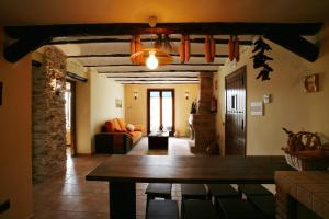 a living room with a wooden table and a couch at Casa Rural Los Pedregales in Carenas