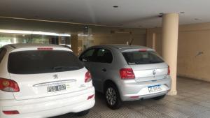 two white cars parked in front of a building at Confortable departamento. Excelente ubicación in Buenos Aires