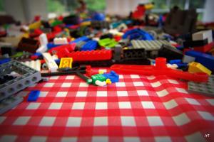 a table with toys on a red and white checkered table cloth at Stutteri Skandihest Apartments in Billund