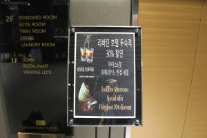 a sign for a menu of a restaurant at Rivertain Hotel Gyeongju in Gyeongju
