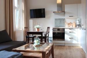 a living room with a couch and a table at Ferienwohnung Goldgrund15 in Meißen