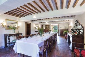 a long dining room with a long table with chairs at Villa Clara in Lucca