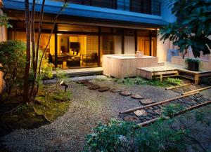 a house with a bench in front of it at Sansuirou in Yugawara