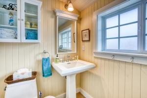 a bathroom with a sink and a window at Seaside Classic Cottage in Seaside +24 photos