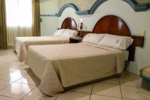 a hotel room with two beds in a room at Motel Caribe in Córdoba