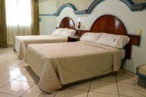 Postel nebo postele na pokoji v ubytování Motel Caribe