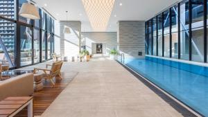 an empty lobby with a pool in a building at Avani Melbourne Central Residences in Melbourne +44 photos