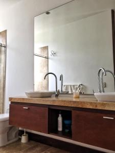 a bathroom with two sinks and a large mirror at Lagos del Peñon: Casa 10 - Puerto Madero in Girardot