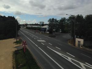 an empty highway with a cross on the road at Family Hôtel FUTUROSCOPE in Jaunay-Clan