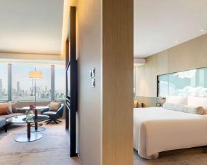 a hotel room with a bed and a tv at Hyatt Centric Victoria Harbour in Hong Kong